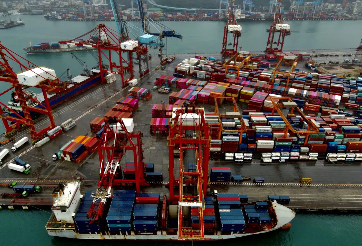 A cargo ship (bottom) being loaded with containers at the harbour in Keelung, Taiwan, on Dec. 8, 2020. (Sam Yeh/AFP via Getty Images)