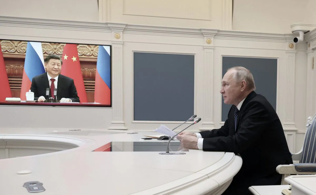 Russian President Vladimir Putin holds a meeting with Chinese leader Xi Jinping via a video link at the Kremlin in Moscow on Dec. 30, 2022. (Mikhail Klimentyev/SPUTNIK/AFP via Getty Images)