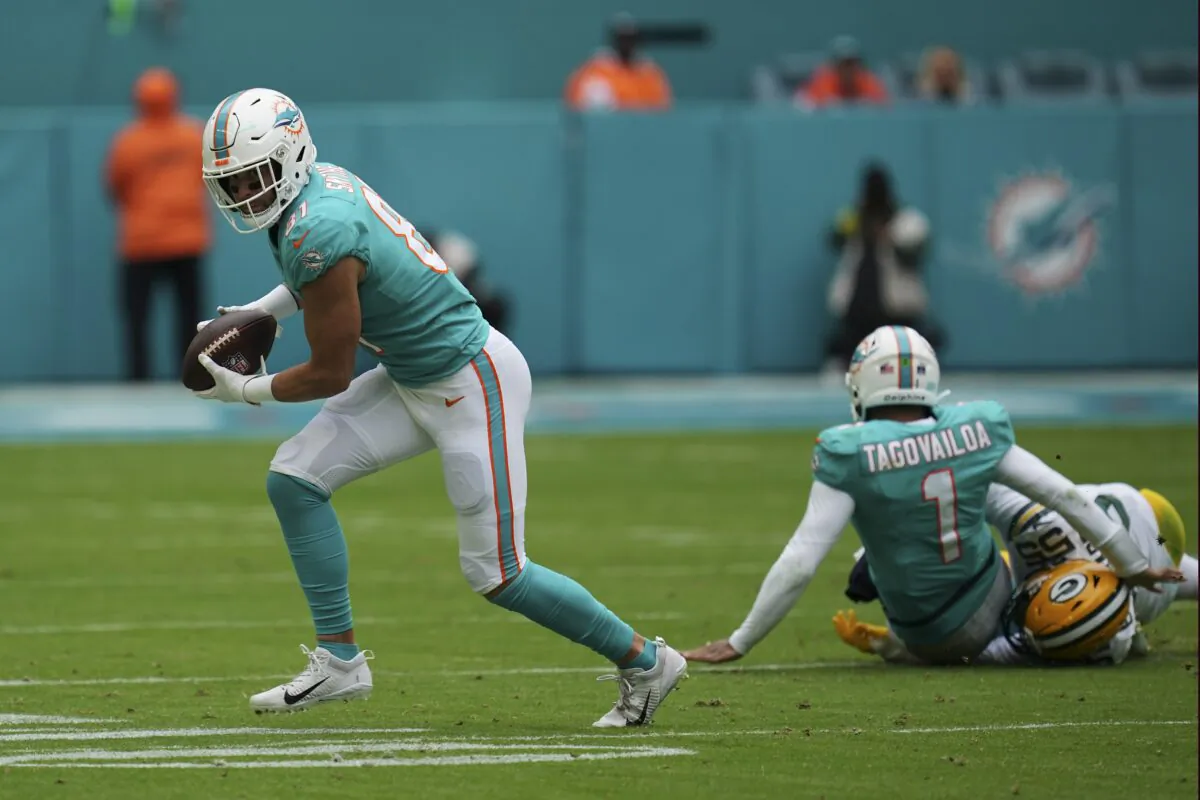 Miami Dolphins quarterback Tua Tagovailoa (1) gets tackled by Green Bay Packers linebacker Kingsley Enagbare (55) after passing the ball to Dolphins tight end Durham Smythe (81), during the first half of an NFL football game in Miami Gardens, Fla., on Dec. 25, 2022. (Jim Rassol/AP Photo)