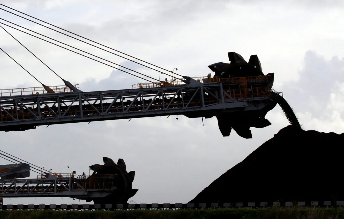 A stacker/reclaimer places coal in stockpiles at the coal port in Newcastle on June 6, 2012. (Daniel Munoz/Reuters)