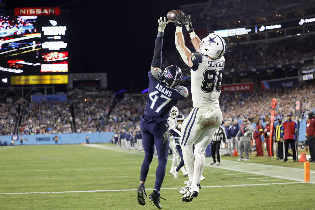 Dalton Schultz (86) of the Dallas Cowboys scores a 10 yard touchdown against Andrew Adams (47) of the Tennessee Titans during the fourth quarter of the game at Nissan Stadium in Nashville on Dec. 29, 2022. (Wesley Hitt/Getty Images)