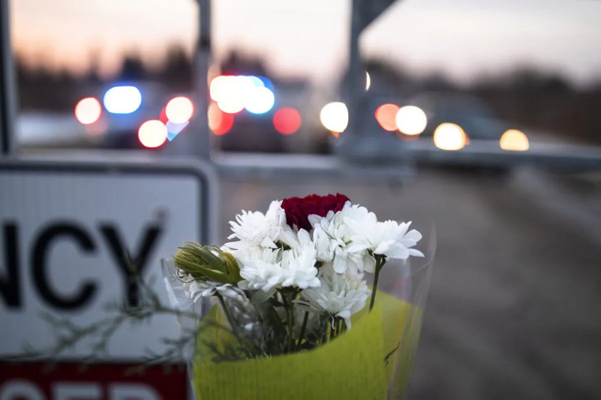 Flowers are left along Indian Line near Hagersville, Ont., Dec. 28, 2022, where an OPP officer was shot and killed. (The Canadian Press/Nick Iwanyshyn)