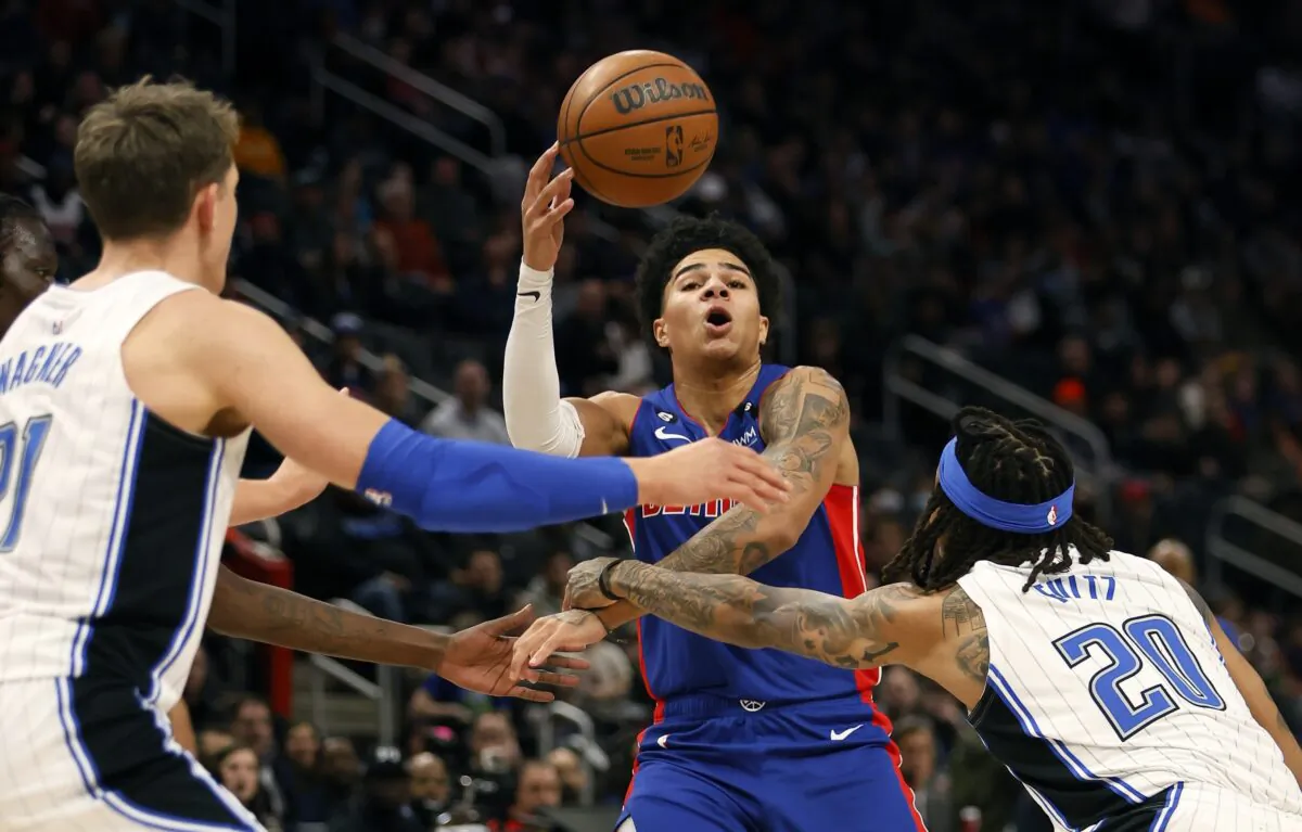 Detroit Pistons guard Killian Hayes (7) is fouled by Orlando Magic guard Markelle Fultz (20) with center Moritz Wagner, left, helping defend during the first half of an NBA basketball game, in Detroit, on Dec. 28, 2022. (Duane Burleson/AP Photo)