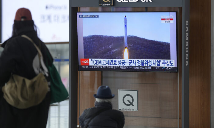 A TV screen shows a file image of North Korea's rocket with the test satellite during a news program at the Seoul Railway Station in Seoul, South Korea, on Dec. 31, 2022. (Lee Jin-man/AP Photo)