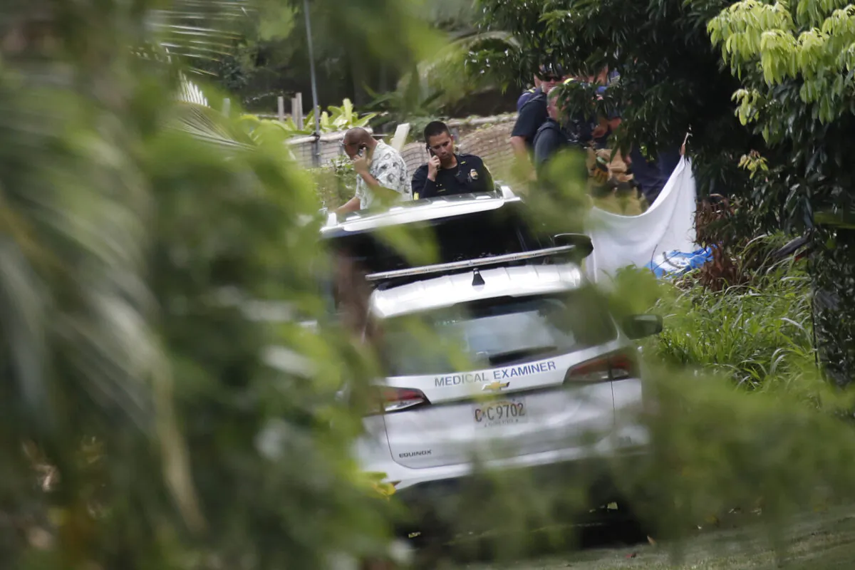 Honolulu police hold an investigation at the scene in Kailua, where at least a man died and a few others were seriously injured while building a retaining wall, in Honolulu on Dec. 30, 2022. (Cindy Ellen Russell/Honolulu Star-Advertiser via AP)