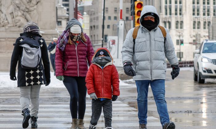 Pedestrians cross the street on Chicago's Michigan Avenue as they brave the freezing weather ahead of the Christmas holiday on Dec. 23, 2022. (Kamil Krzaczynski/AFP via Getty Images)
