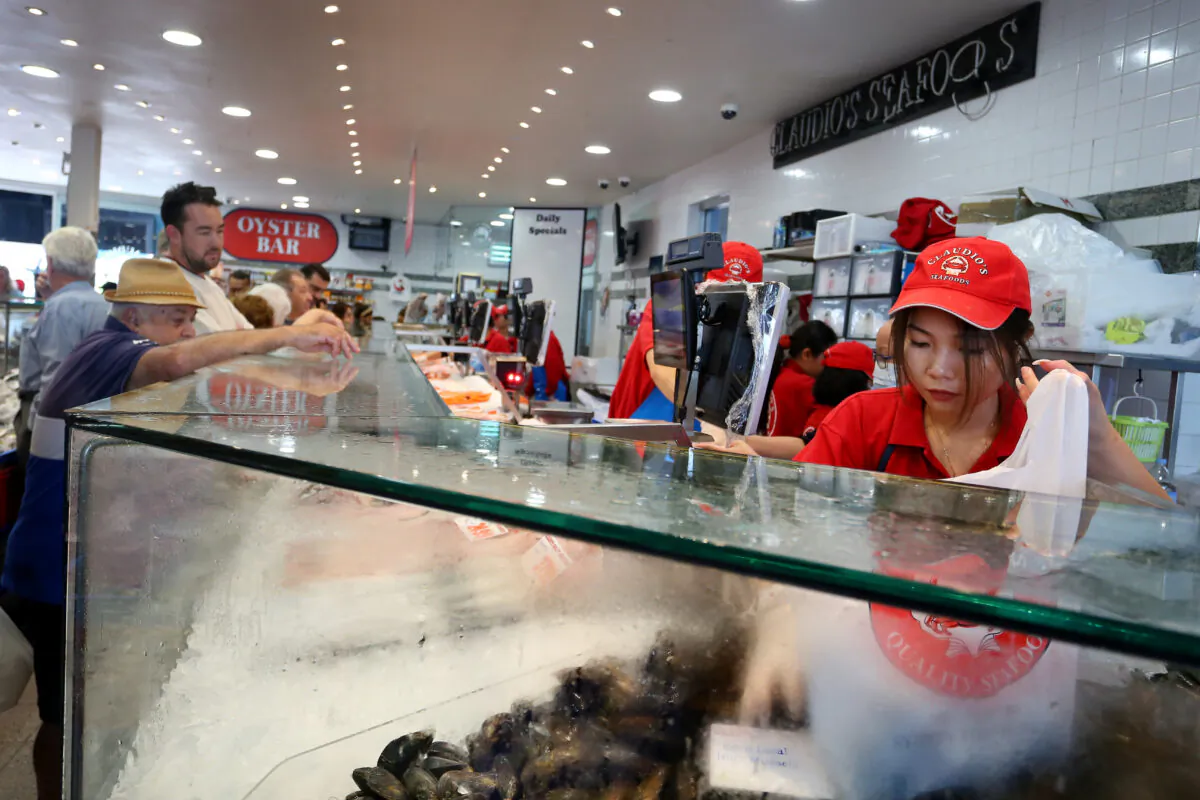 A staff member packs oysters at the Sydney Fish Market in Sydney, Australia, on April 14, 2022. (Lisa Maree Williams/Getty Images)