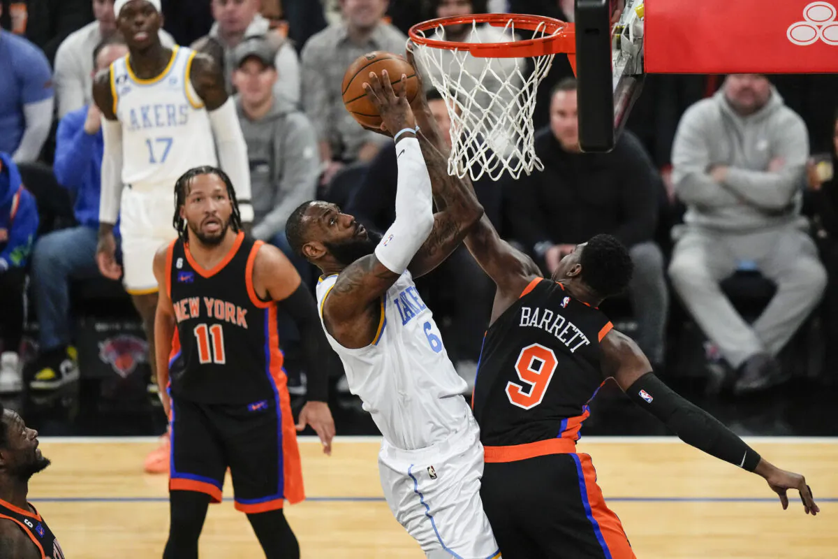 Los Angeles Lakers' LeBron James (6) shoots over New York Knicks' RJ Barrett (9) as Jalen Brunson (11) watches during the first half of an NBA basketball game in New York on Jan. 31, 2023. (Frank Franklin II/AP Photo)