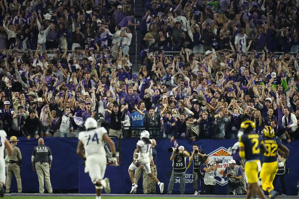 Fans cheer as TCU wide receiver Quentin Johnston (1) runs in for a touchdown during the second half of the Fiesta Bowl NCAA college football semifinal playoff game against Michigan, in Glendale, Ariz., on Dec. 31, 2022. (Ross D. Franklin/AP Photo)