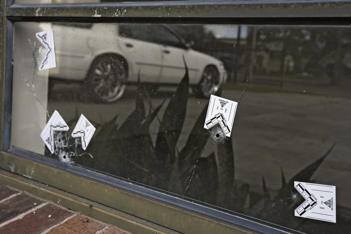 Bullet holes are shown in a window across the street from a shooting location in Lakeland, Fla., on Jan. 31, 2023. (Chris O'Meara/AP Photo)