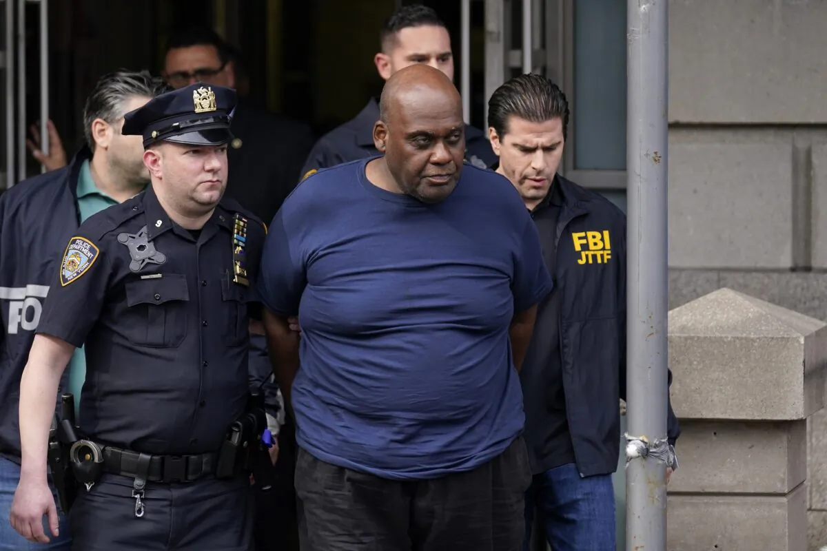 New York City police and law enforcement officials lead subway shooting suspect Frank James, (C), away from a police station in New York on April 13, 2022. (Seth Wenig/AP Photo)