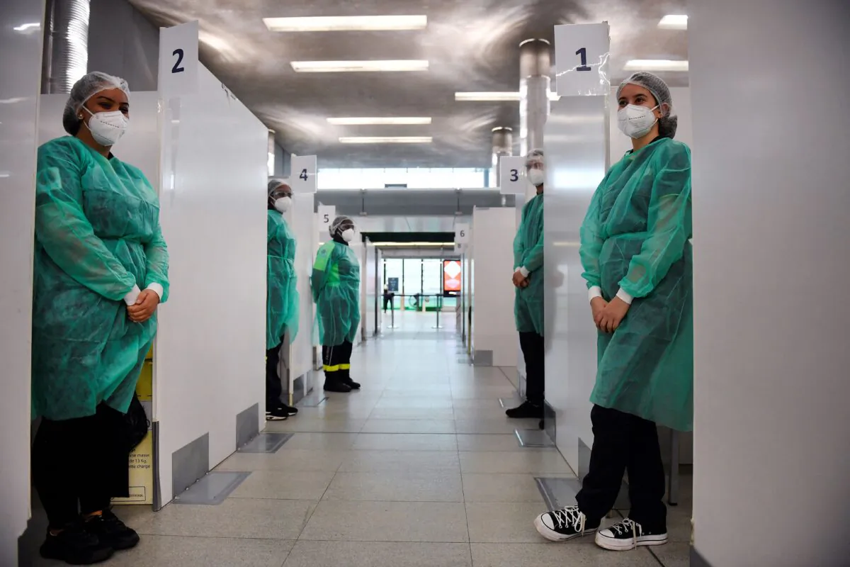 Medical staff of the COVID-19 testing centre near the Paris Charles de Gaulle Airport wait for travellers from China in Roissy, outside Paris, on Jan. 1, 2023. France and Britain on, Dec. 30, 2022, joined a growing list of nations imposing COVID tests on travellers from China after Beijing dropped foreign travel curbs despite its surging cases, and amid questions about its data reporting. (Julien de Rosa/AFP) (Julien de Rosa/AFP via Getty Images)