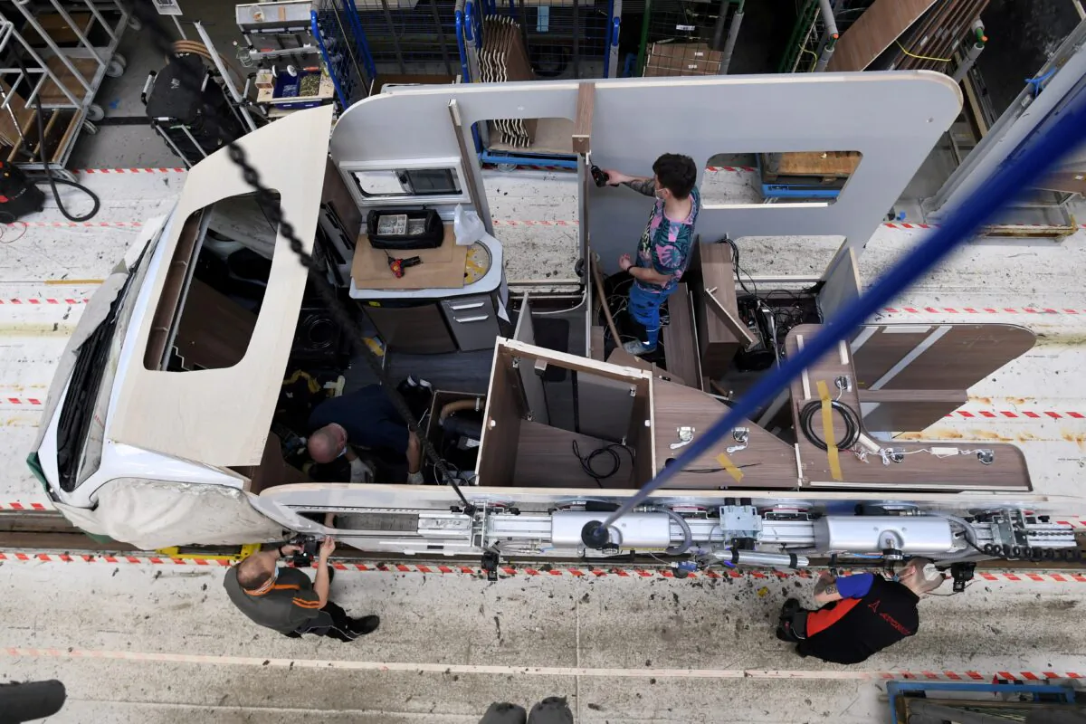 Workers assemble a camper at the Knaus-Tabbert AG factory in Jandelsbrunn near Passau, Germany, on March 16, 2021. (Andreas Gebert/Reuters)