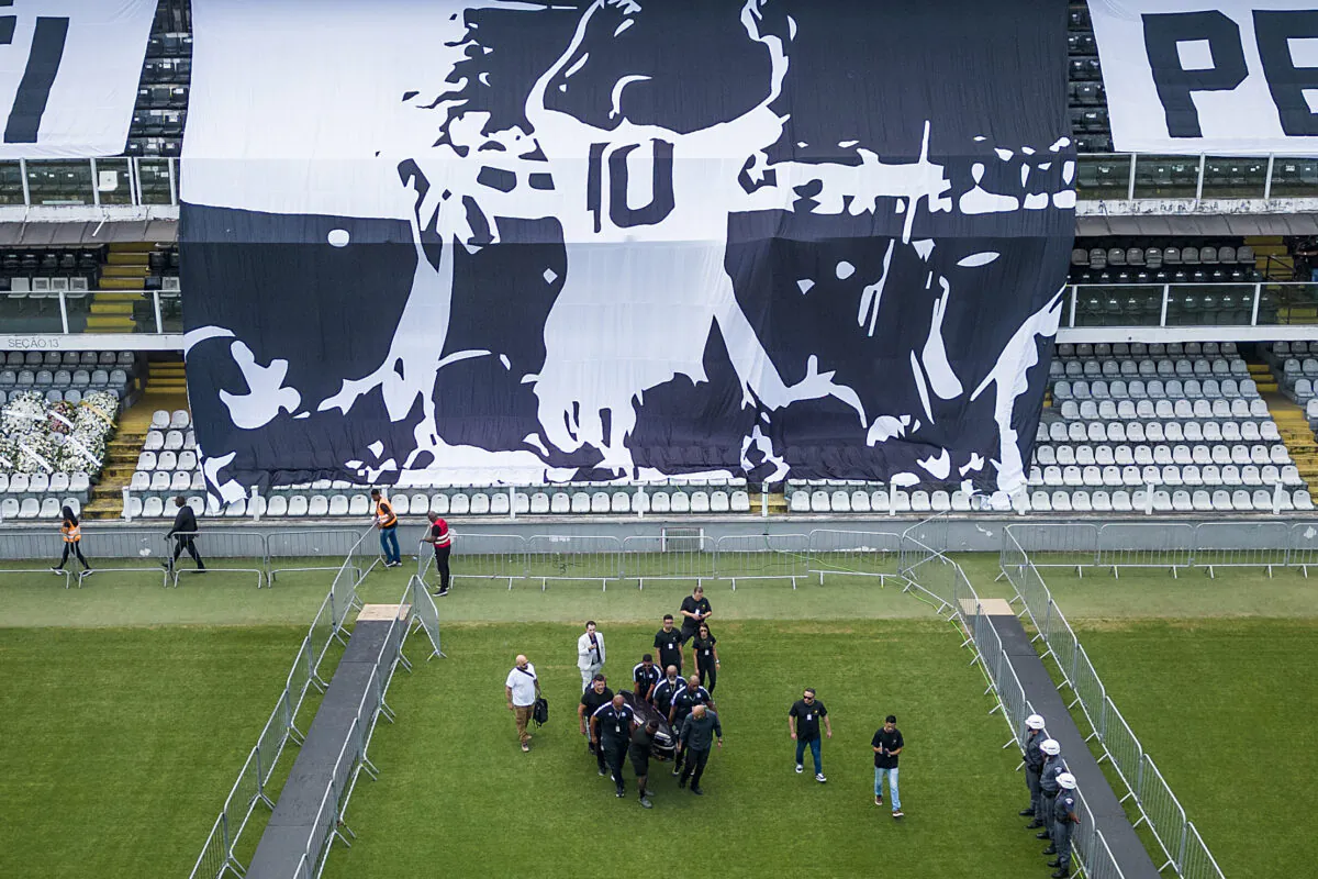 The coffin with the remains of Brazilian soccer great Pele is carried for his wake on the pitch of the Vila Belmiro stadium in Santos, Brazil, on Jan. 2, 2023. (Matias Delacroix/AP Photo)