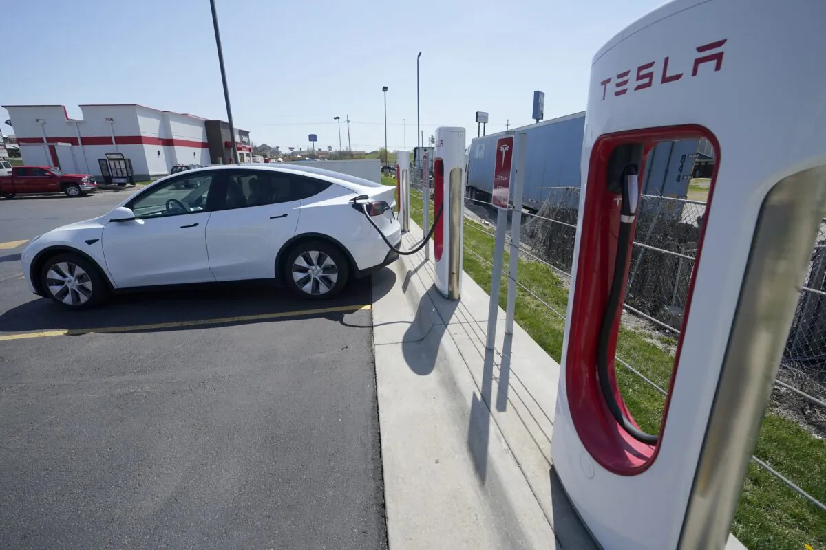 A Tesla charges at a station in Topeka, Kan., on April 5, 2021. (Orlin Wagner/AP Photo)