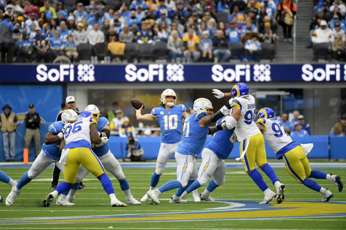 Justin Herbert (10) of the Los Angeles Chargers throws a pass against the Los Angeles Rams during the first half of the game at SoFi Stadium in Inglewood, Calif., on Jan. 1, 2023. (Kevork Djansezian/Getty Images)