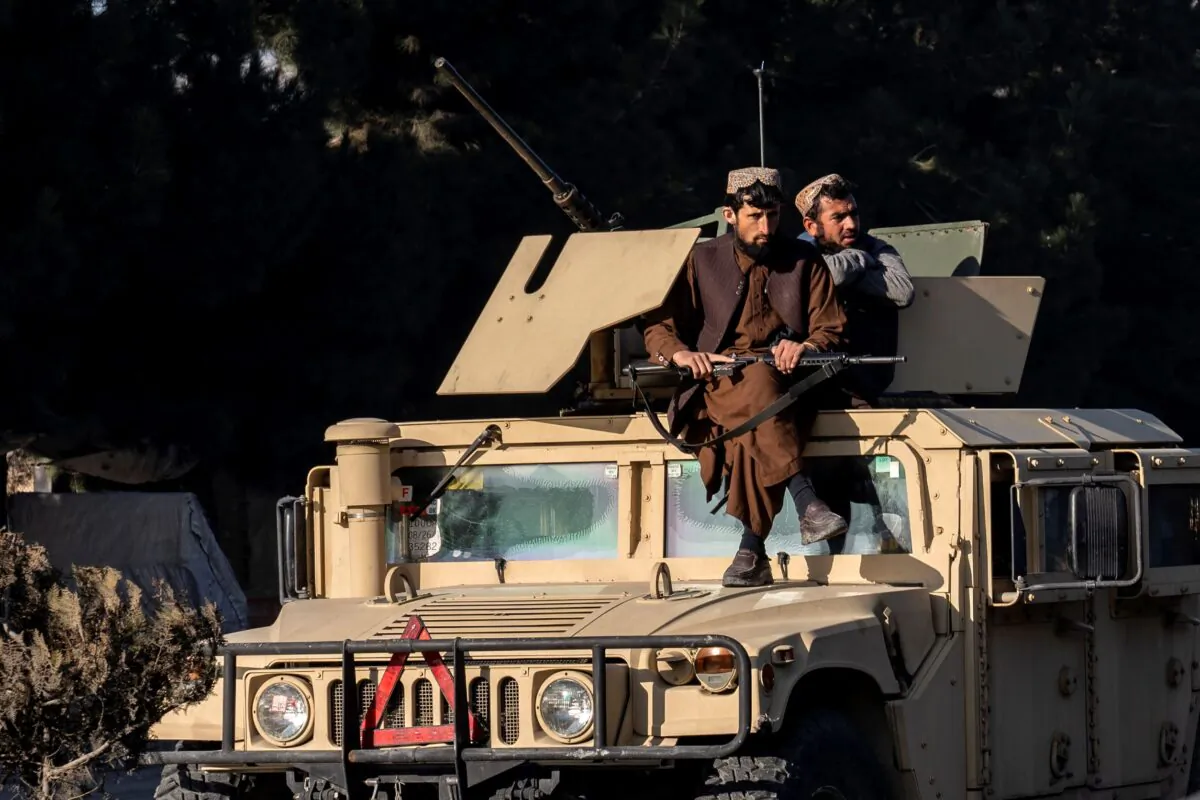 Taliban extremists stand guard at the site of an explosion, near the Interior Ministry, in Kabul, Afghanistan, on Jan. 1, 2023. (Ebrahim Noroozi/AP Photo)