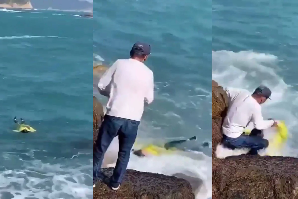 In these stills taken from video an angler is seen pulling in a woman wearing yellow from the waters after falling in, in Hong Kong on Dec. 25, 2022. (Cyrus Chow via Facebook/Screenshot via The Epoch Times/)