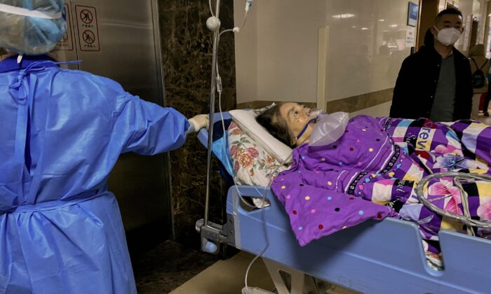 A Covid-19 patient on a stretcher in the emergency ward of the First Affiliated Hospital of Chongqing Medical University in China's southwestern city of Chongqing on Dec. 22, 2022. (Noel Celis/AFP via Getty Images)