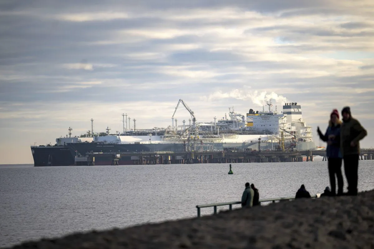 The tanker "Maria Energy", (L), loaded with liquefied natural gas, is moored at the floating terminal, the special ship "Hoegh Esperanza", in Wilhelmshaven, Germany, on Jan. 3, 2023. (Sina Schuldt/dpa via AP)