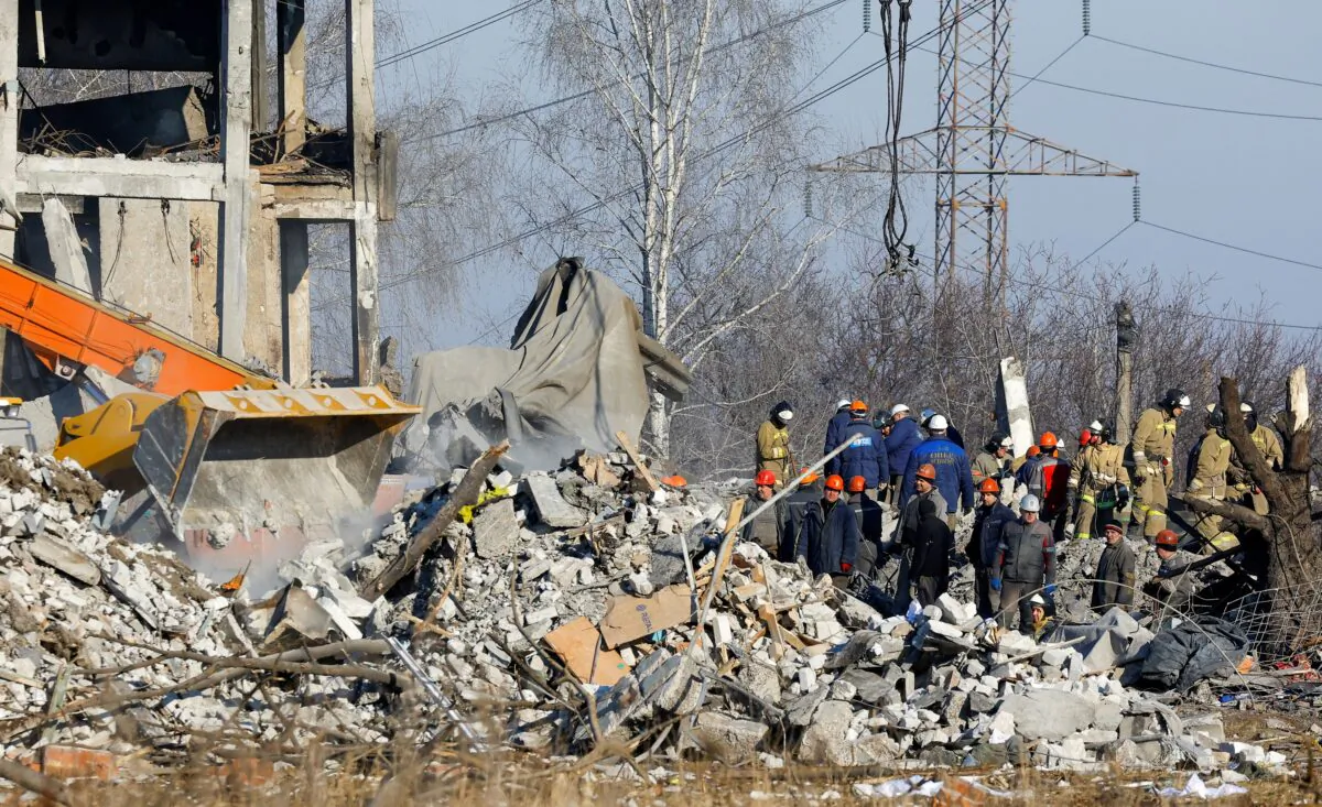 Workers and emergencies' ministry members remove debris of a destroyed building purported to be a vocational college used as temporary accommodation for Russian soldiers, 63 of whom were killed in a Ukrainian missile strike as stated the previous day by Russia's Defense Ministry, in the course of Russia-Ukraine conflict in Makiivka (Makeyevka), Russian-controlled Ukraine, on Jan. 3, 2023. (Alexander Ermochenko/Reuters)