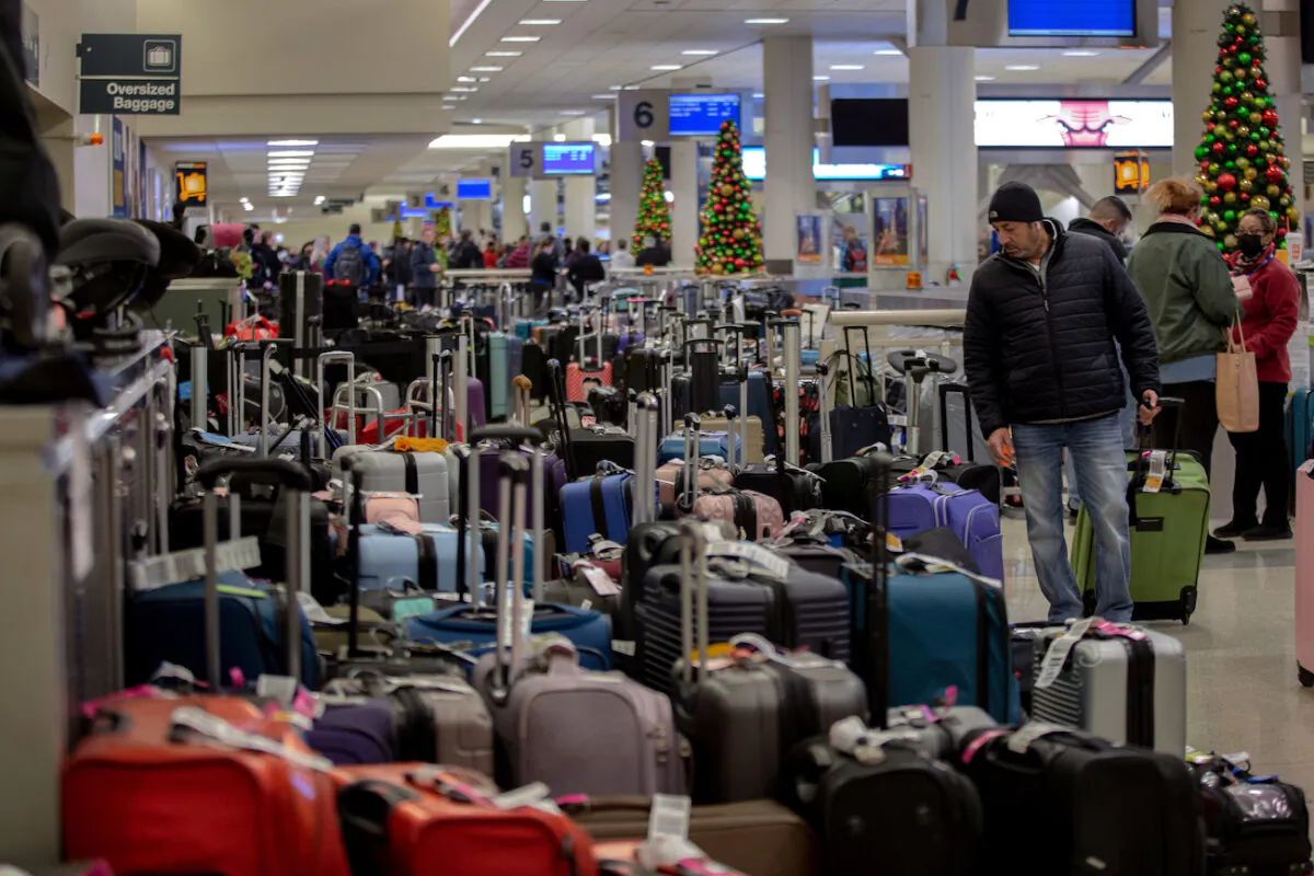 Stranded travellers search for their luggage at the Southwest Airlines baggage claim at Midway Airport, in Chicago, Illinois, on Dec. 27, 2022. (Jim Vondruska/Getty Images)
