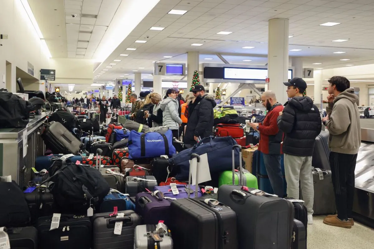 Stranded Southwest Airlines passengers looks for their luggage in the baggage claim area at Chicago Midway International Airport in Chicago, Illinois, on Dec. 28, 2022. (Kamil Krzaczynski/AFP via Getty Images)