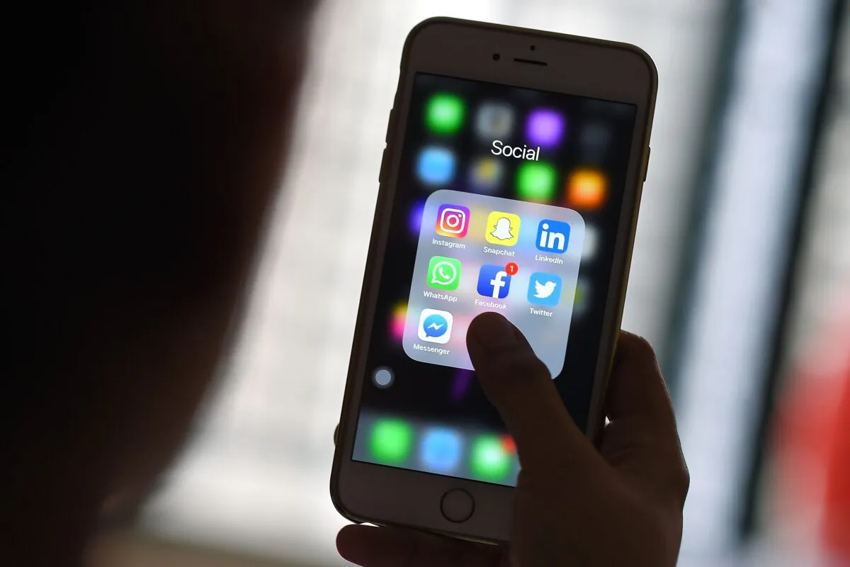 A woman looks at social networking applications on her cellphone in Kuala Lumpur, Malaysia, on March 22, 2018. (Manan Vatsyayana/AFP via Getty Images)