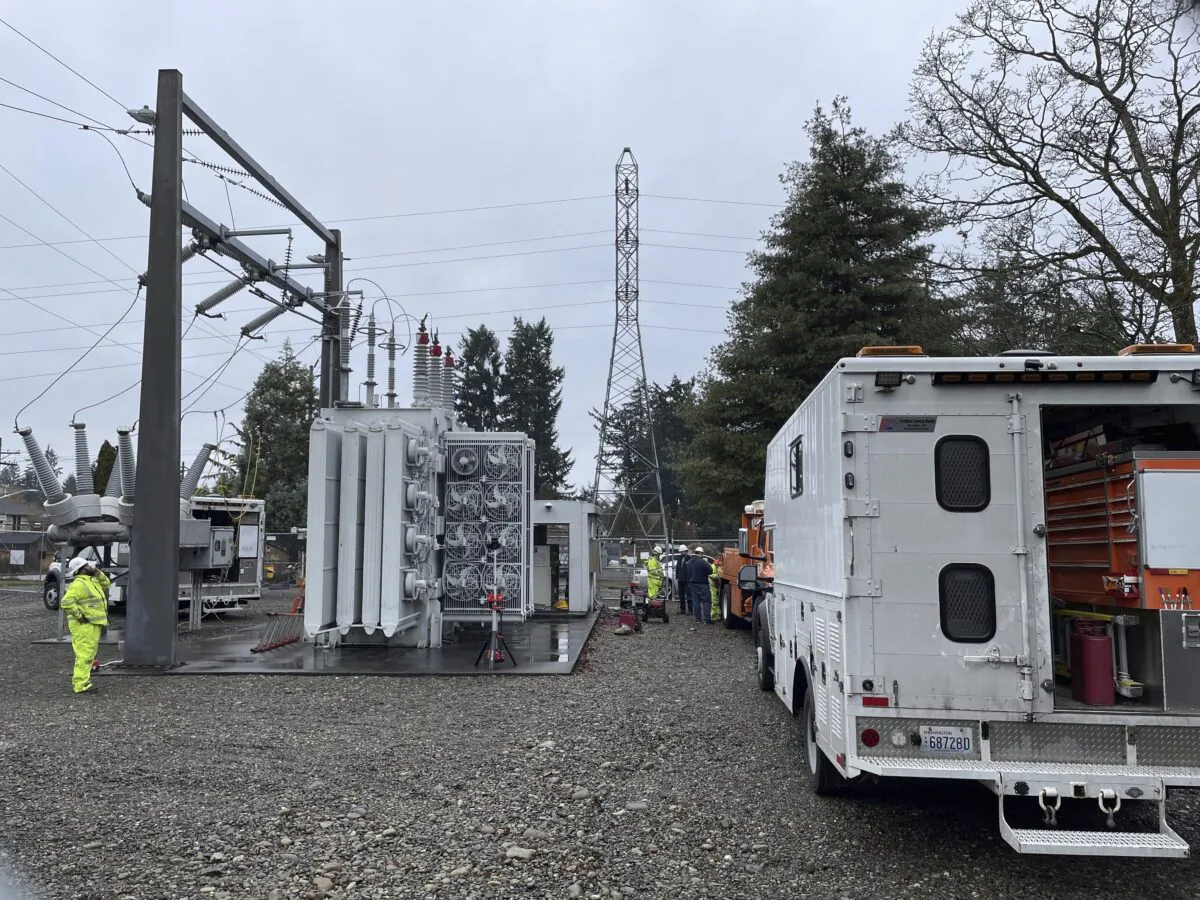 A Tacoma Power crew works at an electrical substation damaged by vandals early on Christmas morning after cutting a padlock to gain entry according to a crew manager in Graham, Wa. on Dec. 25, 2022. (Ken Lambert/The Seattle Times via AP)