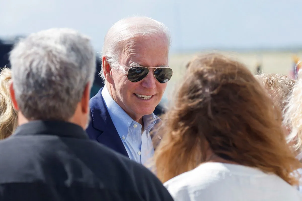 U.S. President Joe Biden speaks with people as he boards Air Force One at Rohlsen Airport to depart after a New Year holiday visit to Christiansted, St. Croix, U.S. Virgin Islands, U.S. on Jan. 2, 2023. (Jonathan Ernst/Reuters)