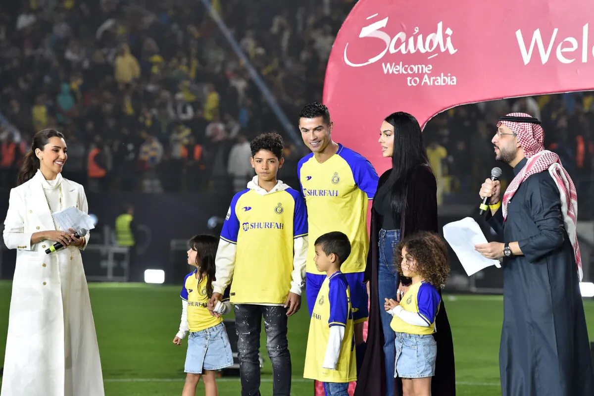 Al-Nassr's new Portuguese forward Cristiano Ronaldo (C), his partner Georgina Rodriguez (C-L) and his children stand on the stage during his unveiling at the Mrsool Park Stadium in the Saudi capital Riyadh on Jan. 3, 2023. (AFP via Getty Images)