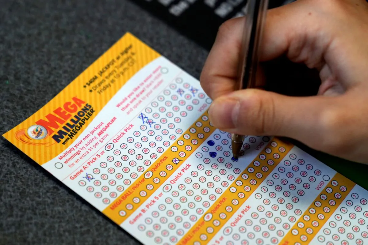 A customer fills out a Mega Millions lottery ticket at a convenience store, in Northbrook, Ill., on Jan. 3, 2023. (Nam Y. Huh/AP Photo)