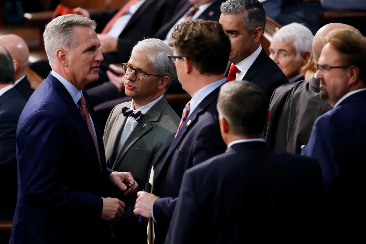 U.S. House Minority Leader Kevin McCarthy (R-Calif.) (L) talks with Rep. Patrick McHenry (R-N.C.) (2nd L) and fellow Republicans in between roll call votes for Speaker of the House of the 118th Congress in the House Chamber of the U.S. Capitol Building in Washington on Jan. 3, 2023. (Chip Somodevilla/Getty Images)