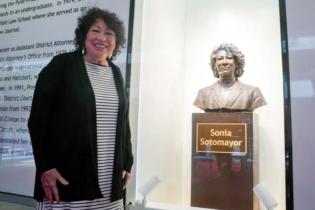Supreme Court Justice Sonia Sotomayor poses for a photo next to a bronze bust of herself after it was unveiled at the Bronx Terminal Market in New York, on Sept. 8, 2022. (Bebeto Matthews/Reuters)