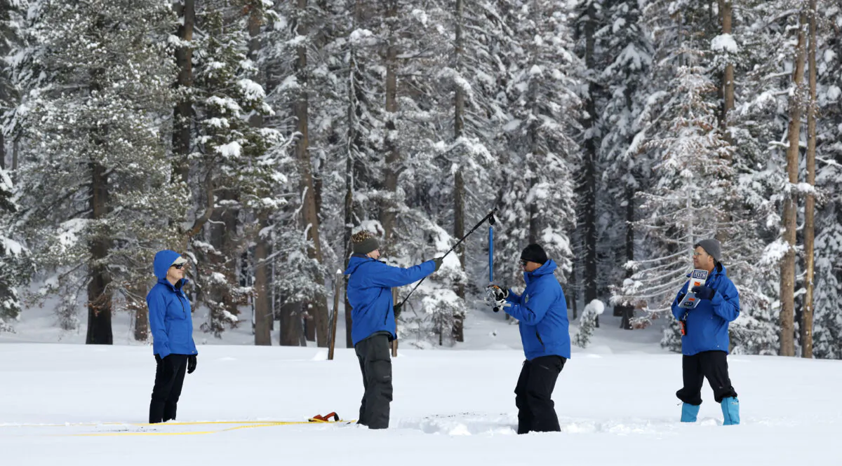 The California Department of Water Resources conducts the first snow survey of the 2023 season at Phillips Station in the Sierra Nevada Mountains in El Dorado County on Jan. 3, 2023. (Fred Greaves/California Department of Water Resources)
