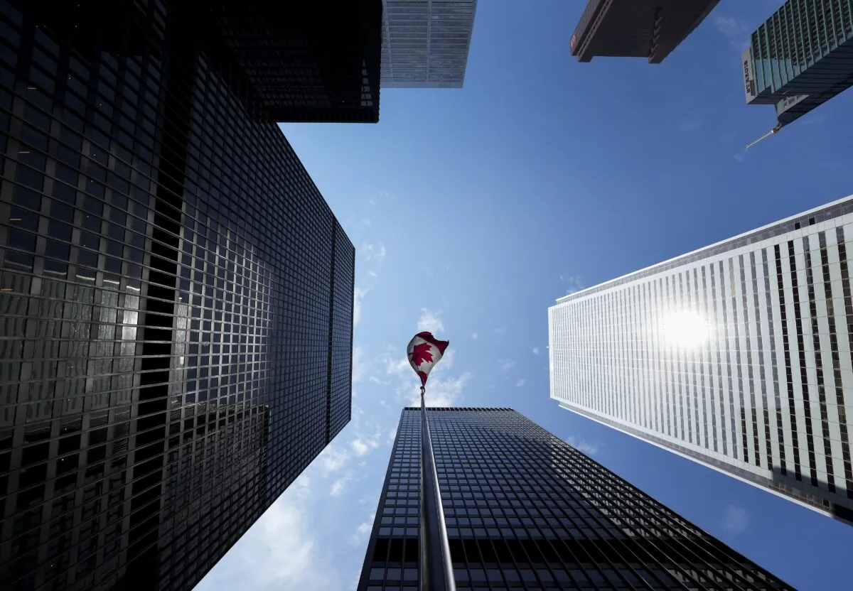 The Bay Street Financial District is shown with the Canadian flag in Toronto on Aug. 5, 2022. (The Canadian Press/Nathan Denette)