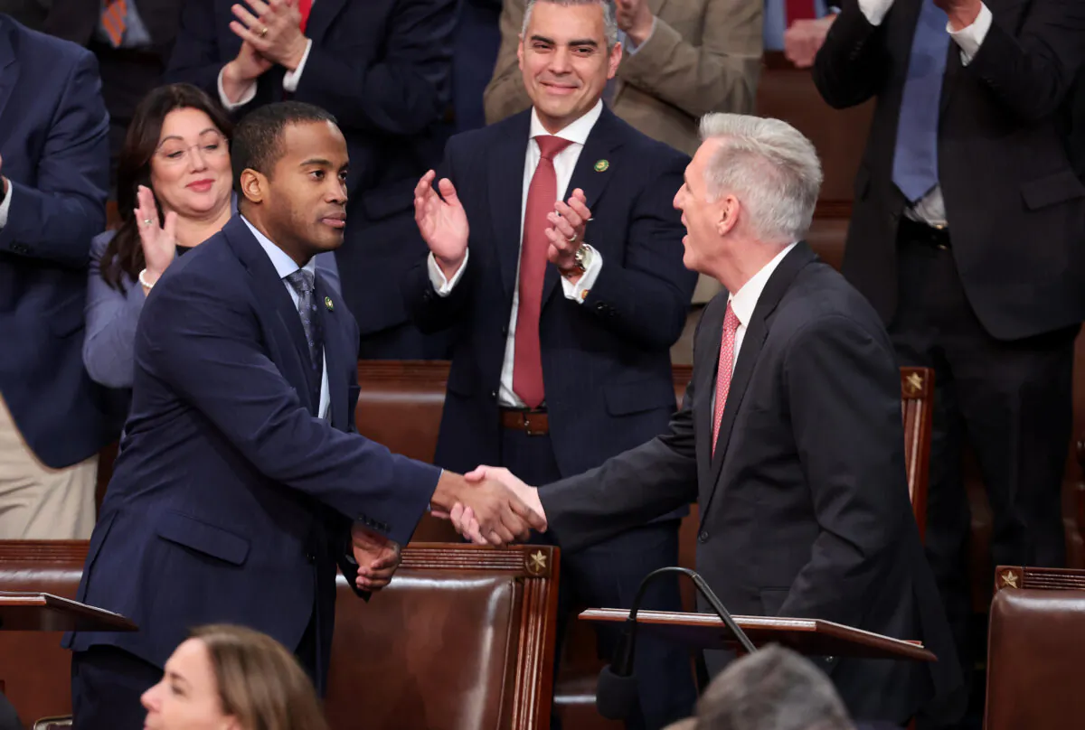 U.S. House Republican Leader Kevin McCarthy (R-Calif.) (R) shakes hands with Rep.-elect John James (R-Mich.) in the House Chamber during the third day of elections for Speaker of the House at the U.S. Capitol Building in Washington on Jan. 5, 2023. (Win McNamee/Getty Images)
