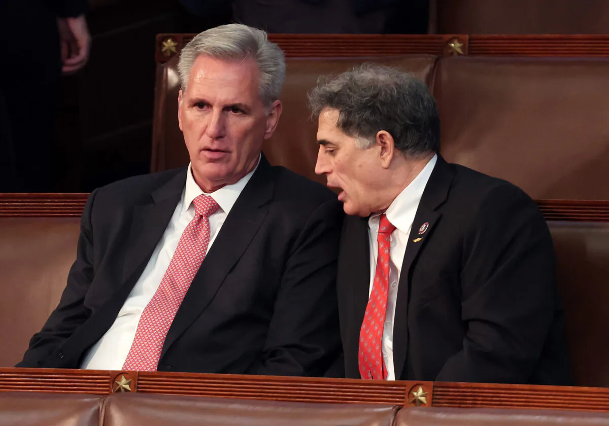 House Republican Leader Kevin McCarthy (R-Calif.) (L) talks to Rep.-elect Andrew Clyde (R-Ga.) in the House Chamber during the third day of elections for Speaker of the House at the U.S. Capitol Building in Washington on Jan. 5, 2023. (Win McNamee/Getty Images)