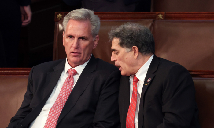 House Republican Leader Kevin McCarthy (R-Calif.) (L) talks to Rep.-elect Andrew Clyde (R-Ga.) in the House Chamber during the third day of elections for Speaker of the House at the U.S. Capitol Building in Washington on Jan. 5, 2023. (Win McNamee/Getty Images)