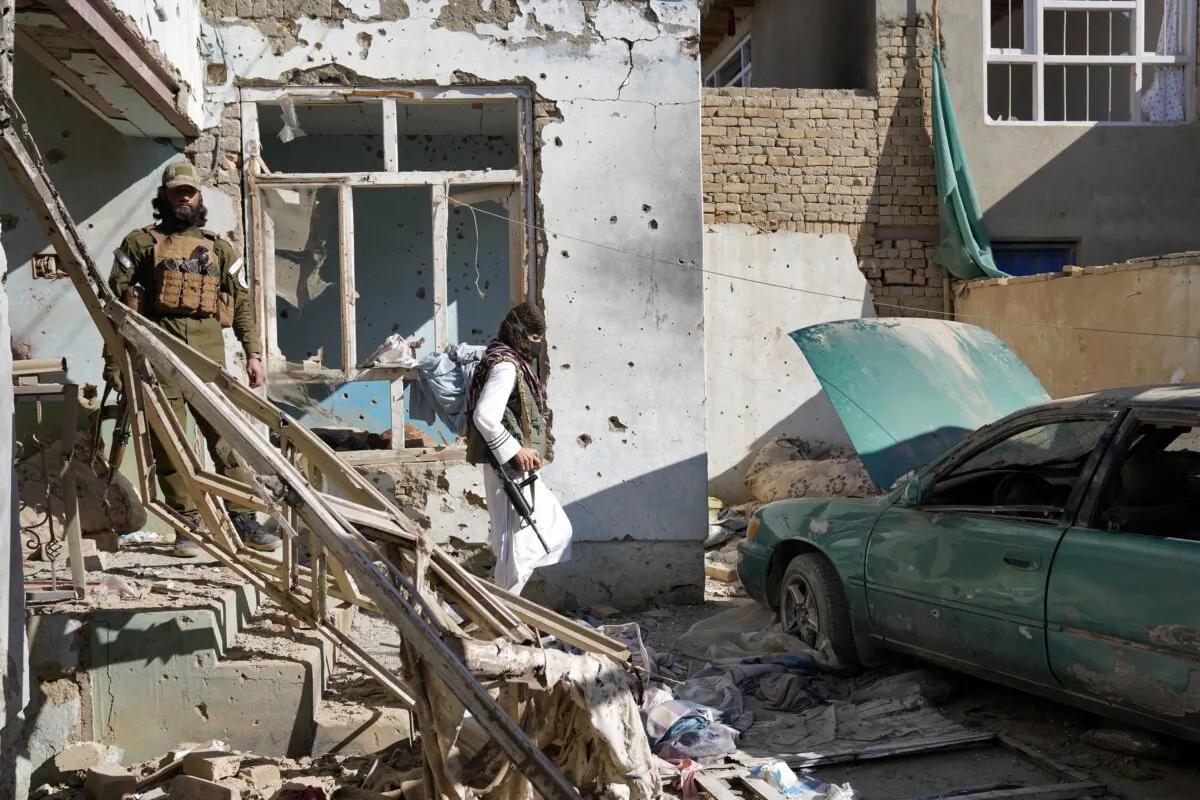 Taliban terrorists check an ISIS group house that was destroyed in the ongoing conflict between the two in Kabul, Afghanistan, on Jan. 5, 2023. (Ebrahim Noroozi/AP Photo)