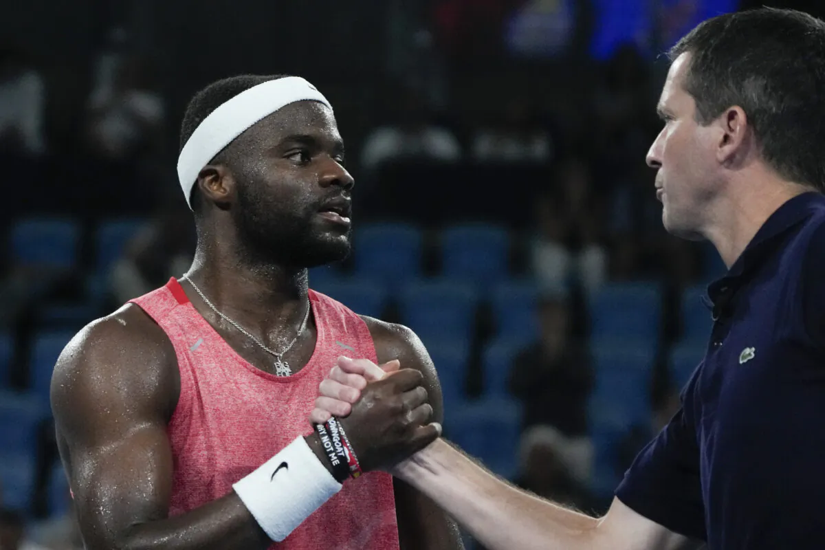 United States' Frances Tiafoe, left, is congratulated by Great Britain's team captain Tim Henman after defeating Britain's Daniel Evans in their match at the United Cup tennis event in Sydney, Australia, on Jan. 4, 2023. (Mark Baker/AP Photo)