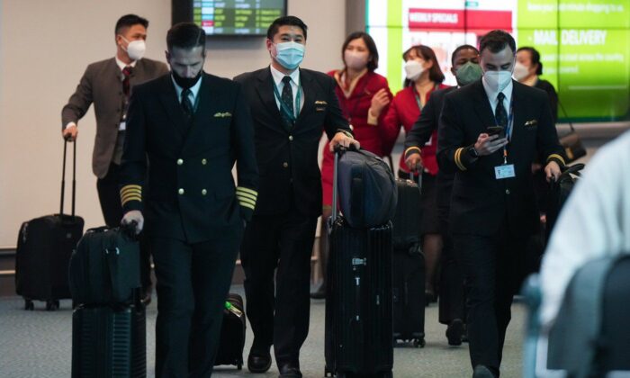 Cathay Pacific crew members who worked on a flight from Hong Kong arrive at Vancouver International Airport, in Richmond, B.C., on Jan. 4, 2023. (The Canadian Press/Darryl Dyck)
