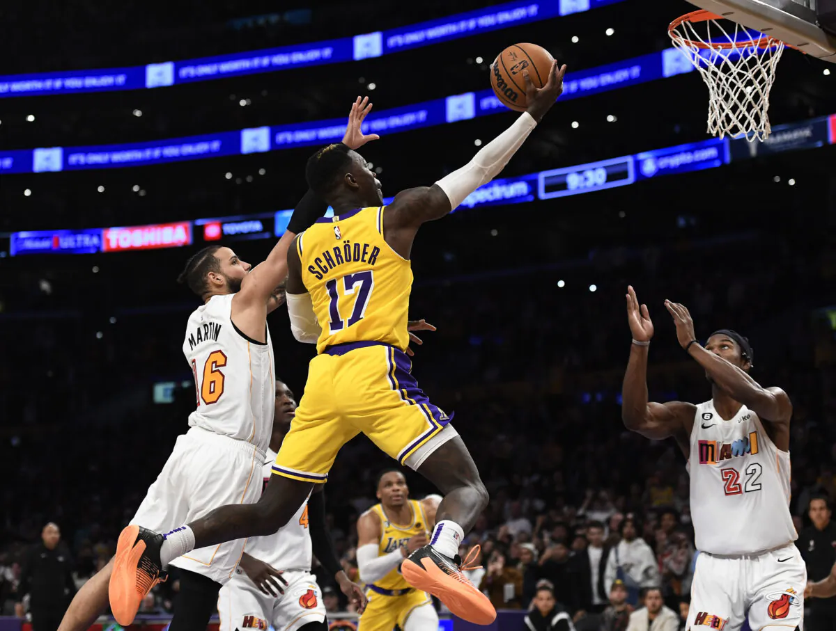 Dennis Schroder (17) of the Los Angeles Lakers scores a basket and is fouled by Caleb Martin (16) of the Miami Heat late in the second half in Los Angeles on Jan. 4, 2023. (Kevork Djansezian/Getty Images)