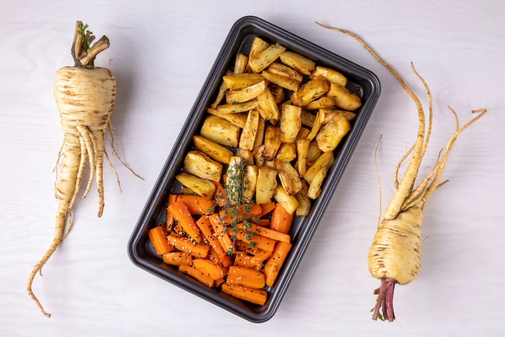 Parsnips can be cooked like carrots—boiled and buttered, cooked with peas, or chopped in stew, to name a few. (Fotema/Shutterstock)