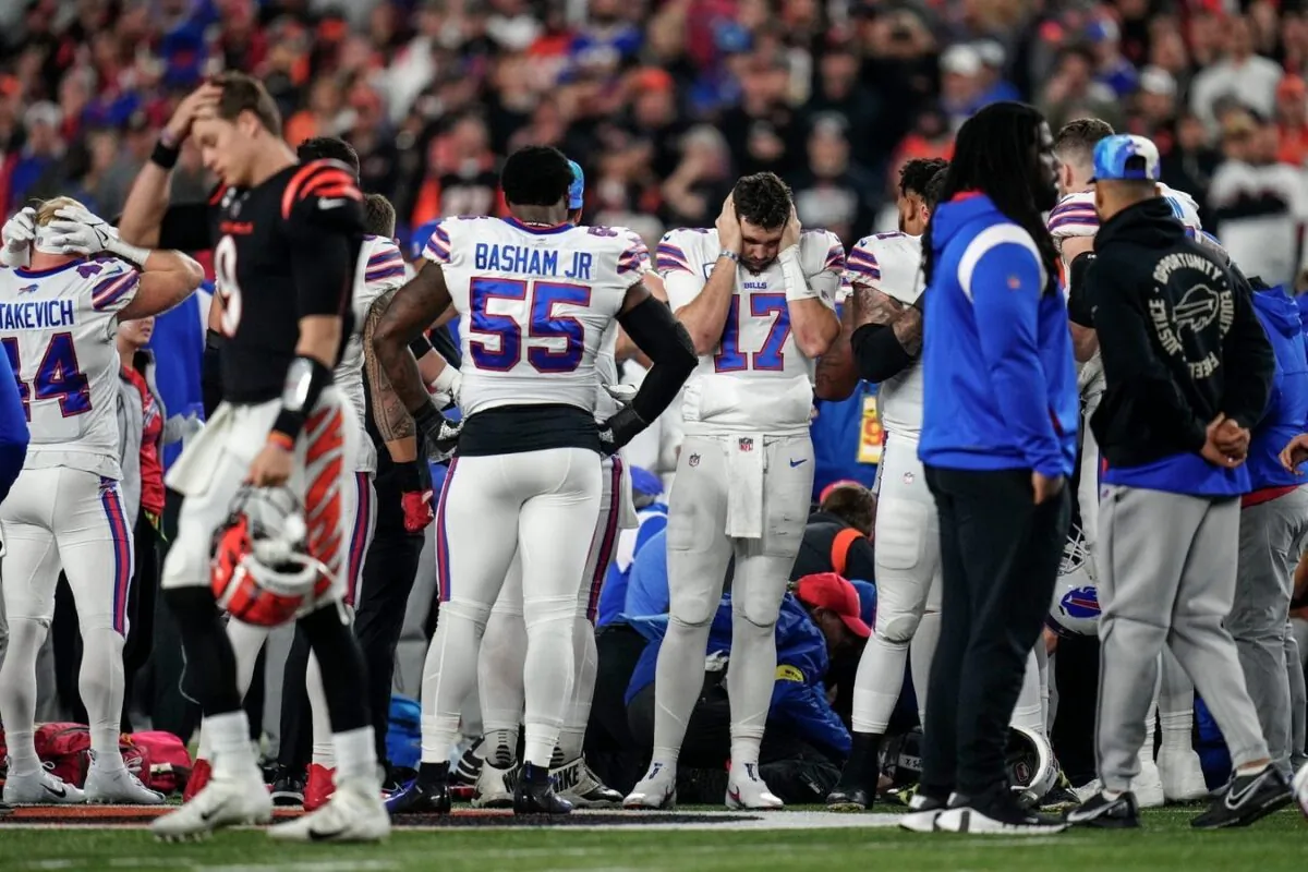 The Buffalo Bills gather while CPR is administered to Damar Hamlin at the game against the Cincinnati Bengals at Paycor Stadium in Cincinnati, Ohio, on Jan. 2, 2023. (Sam Greene/USA Today Sports via Field Level Media)