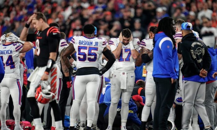 The Buffalo Bills gather while CPR is administered to Damar Hamlin at the game against the Cincinnati Bengals at Paycor Stadium in Cincinnati, Ohio, on Jan. 2, 2023. (Sam Greene/USA Today Sports via Field Level Media)