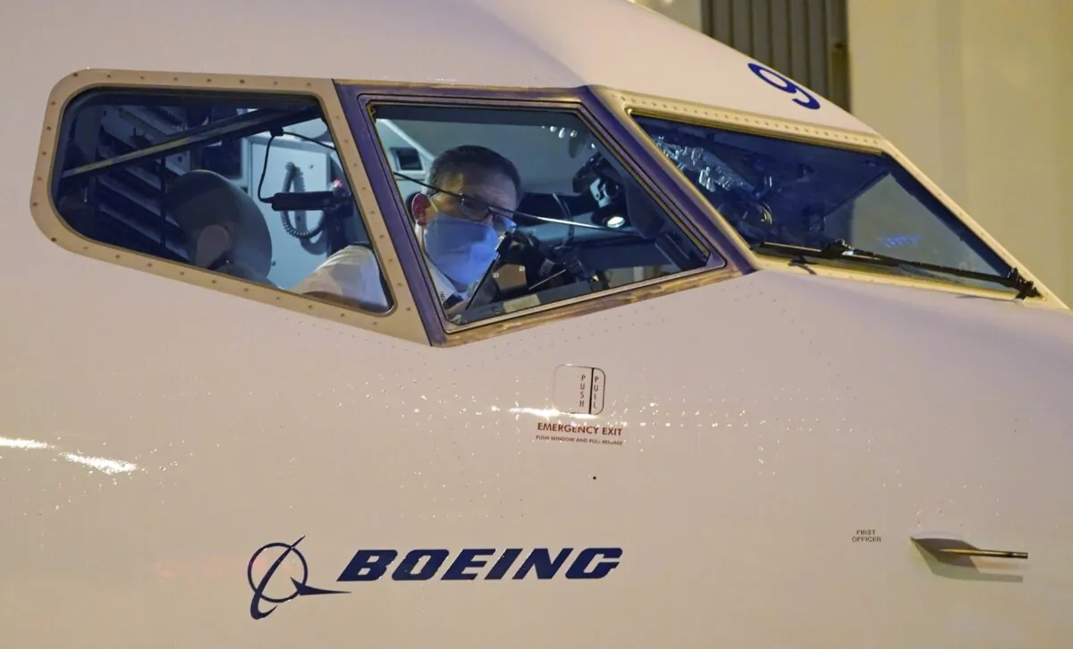 Capt. Brian Eyre, who was serving as first officer, goes through pre-flight preparations in the flight deck before the first Alaska Airlines passenger flight on a Boeing 737-9 Max airplane, on March 1, 2021. (Ted S. Warren/AP Photo)