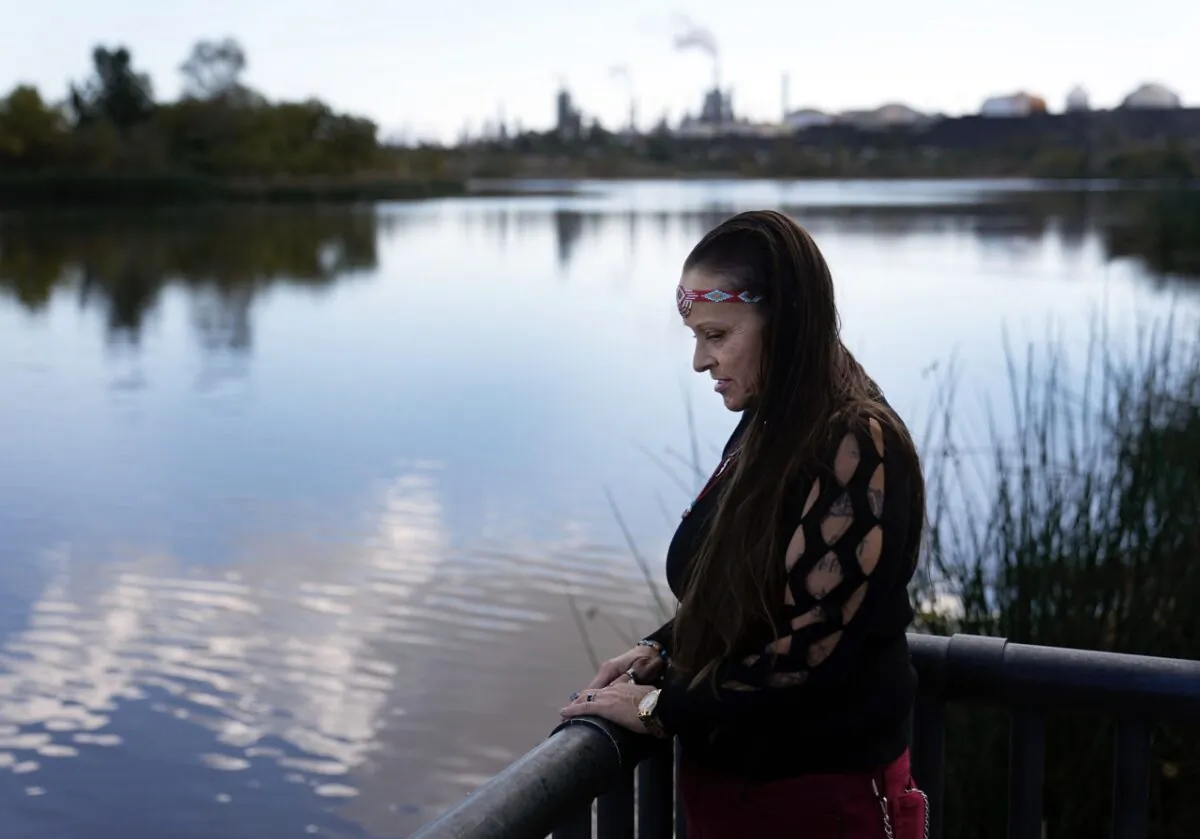 Moonlight Pulido stands by the shore at Harbor Lake in Los Angeles, on Dec. 7, 2022. (Marcio Jose Sanchez/AP Photo)