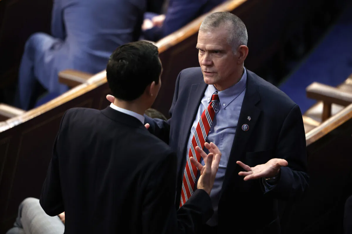 Rep. Matt Rosendale (R-Mont.) (R) speaks with John Leganski, Deputy Chief of Staff for Rep. Kevin McCarthy (R-Calif.) on the House floor during the fourth day of voting for House Speaker on Jan. 6, 2023. (Chip Somodevilla/Getty Images)