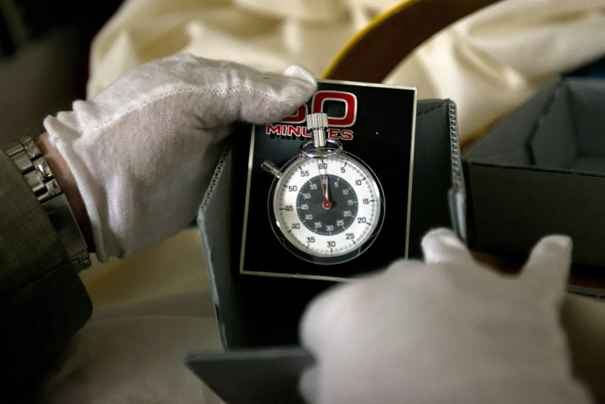 Dwight Bowers, Curator of Division of Culture and the Arts, holds the stopwatch used on the TV news magazine show "60 Minutes" in the vaults at the Smithsonian's American History Museum, in Washington, D.C., on July 27, 2012. (Brendan Smialowski/AFP/GettyImages)